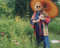 Lorrie Otto standing before her native landscaped yard. Photo by Ney Tait Fraser.
