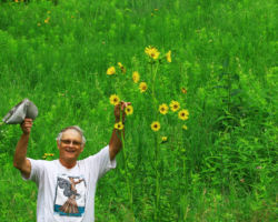 Eldred in the Iris Drive Prairie in Crawford County, WI celebrating a compass plant. 2016. Photo by Steve Qucrin Schultz.