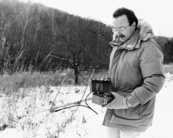 Temple radio-tracking free-ranging house cats in rural Wisconsin. 1992. Photo courtesy of UW-Madison.