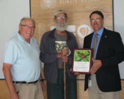 Noel Cutright (center) received an award for his service to Wisconsin's birds from DNR Lands Division Administrator Kurt Thiede (right), while on the Larry Meiller (left) show. 2013. Photo by Judith Siers-Poisson. https://www.wpr.org/state-dnr-recognizes-longtime-bird-advocate