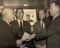 CH Stoddard taking the Oath of Office upon his appointment by Interior Secretary Stewart Udall as Director of the Bureau of Land Management. The photo was taken on June 5, 1963. CHS is flanked by Senator Gaylord Nelson and Secretary Udall. A photo of then-President Kennedy appears on the wall between Udall and Nelson. Mr. Floyd E. Dotson is person swearing in Director Stoddard.