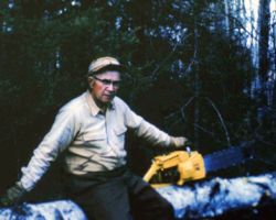 Fred Schmeeckle cutting wood for his home in Eagle River. 1963.