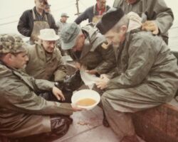 Governor Warren Knowles (in white hat) watches fisheries staff extracting spawn from rainbow trout as "Toots" Winegar, commercial fisherman, looks on. 1969. Photo by Staber W. Reese. Courtesy of UW-Madision Digital Archives.