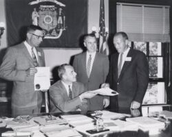 Al Niebuhr (far left) and Don Gruel (far right), both fish management personnel, receiving merit awards from Governor Gaylord Nelson (seated). Conservation department director Lester P. Voigt is standing next to Governor Nelson. Circa 1960. (Photo by Dean Tvedt. Courtesy of UW-Madison Digital Archives.)