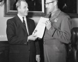 Governor Gaylord Nelson presenting conservation warden David Hammes a merit award for the development of a device to determine whether a shotgun could hold the proper number of shells. 1959. Photo by Dean Tvedt. (Photo courtesy of UW-Madison Digital Archives.)