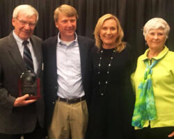 Arlen received the Distinguished Alumni Award from UW-River Falls. Pictured with son John, daughter Anne and wife Judy. 2018. (Photo courtesy of Christenson Family.)