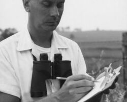 C. D. Besadny making a field check on pheasant cover conditions. 1965. (Photo by Dean Tvedt. Courtesy of Wisconsin DNR and UW Madison Digital Archives.)