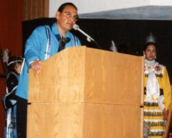 Many times he and the Menominee formed coalitions with others interested in environmental protection. At the same time, Waukau considered it essential that the Menominee and other Native Americans protect their separate and distinct culture. Pictured is a speaker at Waukau's Induction. 2001. (Photo courtesy of the WCHF.)
