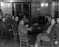 Richard Hemp (checked shirt, front right) at a public meeting for Bayfield, Ashland and Douglas Counties at the Brule Ranger Station. Sportsmen and deer committee of the Conservation Congress. 1948. (Photo courtesy of Wisconsin DNR.)