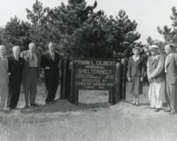 Frank L Gilbert Shelterbelt. L-R: Merton Peavy, Louis Hobbins, H. W. MacKenzie, Ivan Ley, Mrs. Devine, William Sowles Sr., Frederick C. Wilson (WCHF Inductee). (Photo courtesy of Wisconsin DNR.)