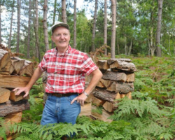 2000 Keith showing that fringe benefits of owning some land include firewood, an annual Christmas tree, hunting, camping without competition, and practicing his forestry training on one's own land. The 84 acres acquired in 1976 are enrolled in a Conservation Easement and are under the Managed Forest Law. :(Photo by Pat Durkin in early 2000s)
