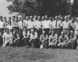 DNR Bureau of Research members at an annual meeting, early 1970s. This Bureau offered the structure into which Keith McCaffery fit his distinguished research career. From this group, came NINE Hall of Fame inductees, 7 of whom are in this photo! (Photo credit DNR) HoF inductees can be spotted as follows: Kneeling are Keith (3rd from the left), Richard Hunt (5th from the left), and Clifford Germain (2nd from the right). In the front row standing are Robert Hunt (immediately to the right of the gentleman in the striped shirt) and C.D. Besadny (wearing a tie, 4 to the right of Robert Hunt). In the back row are Melville Cohee (close to the center of the photo, wearing glasses) and Ruth Hine (2 to the right of Melville Cohee). Absent from this meeting and photo were Frederick and Frances Hamerstrom.