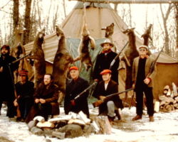Keith's deer camp on the Jump River in Price County during the Seventies and Eighties. Keith's dad is in the center with brother Mike to photo left, Keith to the right, and brother Wayne far right. Three close friends of Keith's brothers are included. Photo taken while pretending to be in the Thirties, except for the red caps and dark glasses! Campers outgrew the tent as younger generation was added. In the Nineties, some of us moved to our pole cabin a few miles away.