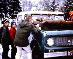 1960 Neighborhood kids gathered to watch while Burt Cornell registered a deer at the Rhinelander Ranger Station during a gun deer season in the Sixties.